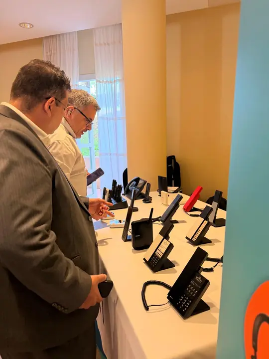 Attendees trying out Snom IP desk phones at the event showcase