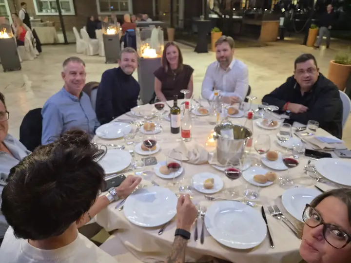 Snom team and distributors at an evening dinner table