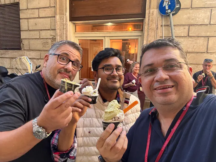 Event attendees enjoying gelato together on a street in Rome